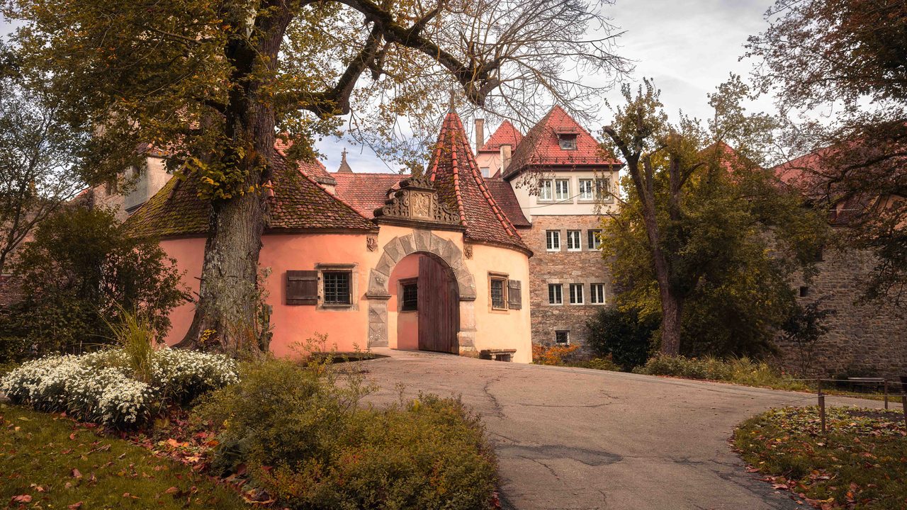 A gatehouse under bare trees.