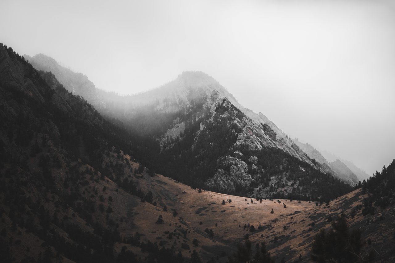A snow peak standing inside cloud.