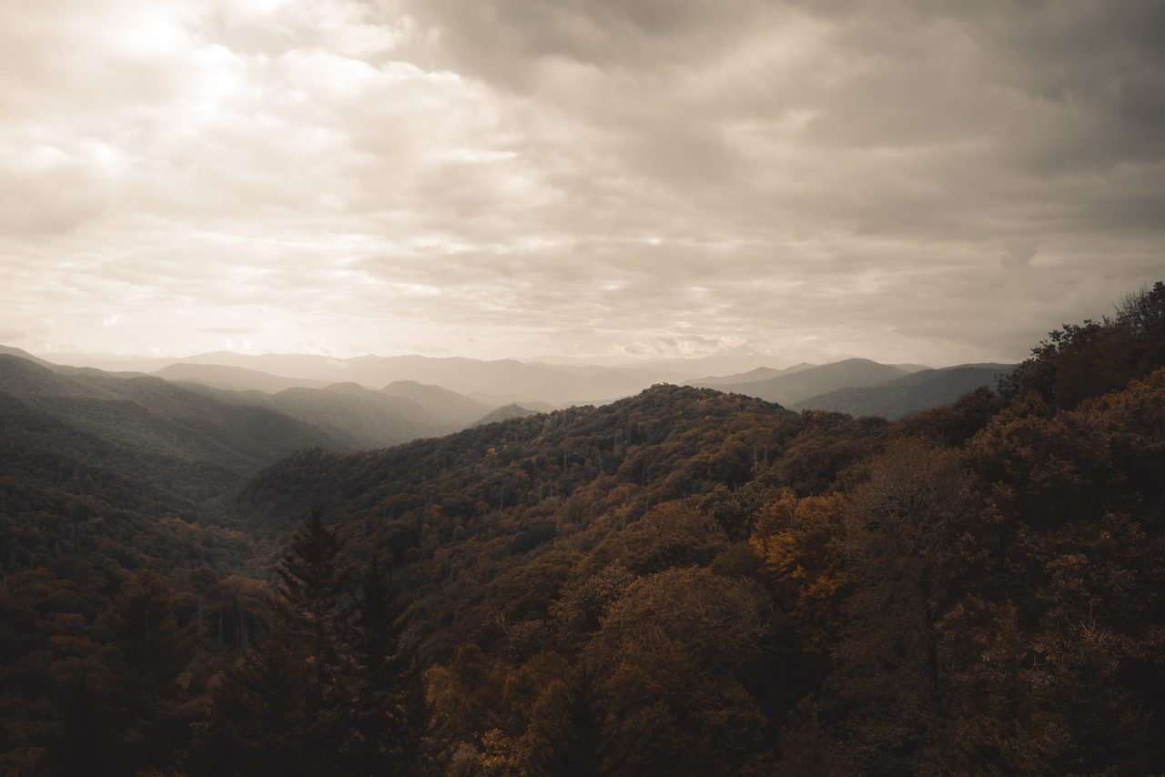 Autumn ridges under a silver sky.